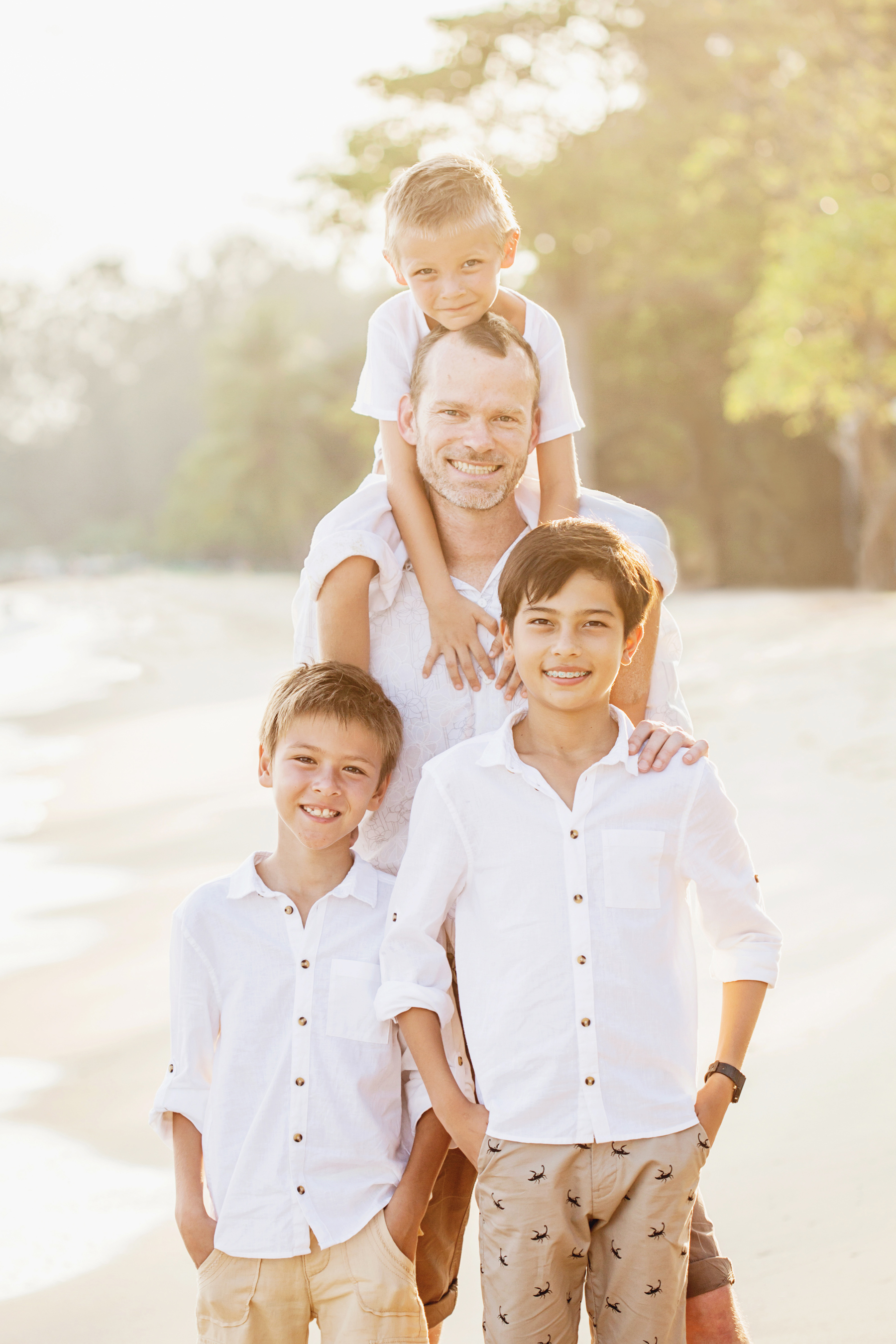 Lifestyle portrait of Father and sons at the beach